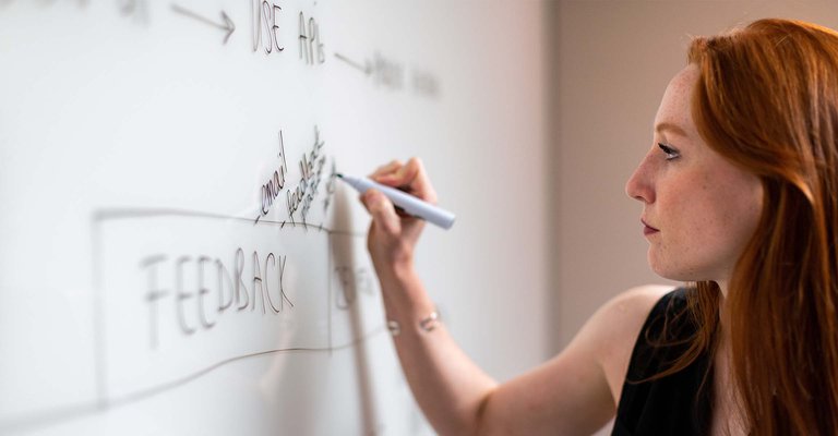 woman writing on whiteboard